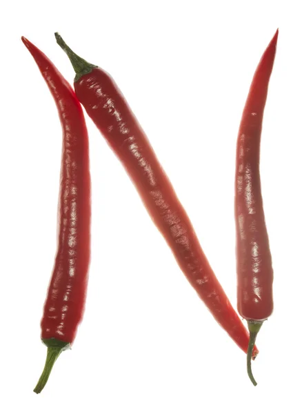 "N" letter made of chili peppers on white background — Stock Photo, Image