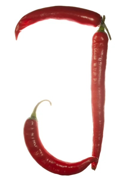"J "litera wykonana z papryki chili na białym tle — Zdjęcie stockowe