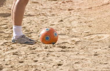 Foot player in beach soccer clipart