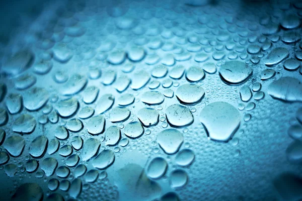 Abstract blue bubbles background. Liquid on dirty glass — Stock Photo, Image