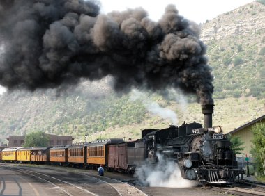 Departure of an old steam locomotive clipart