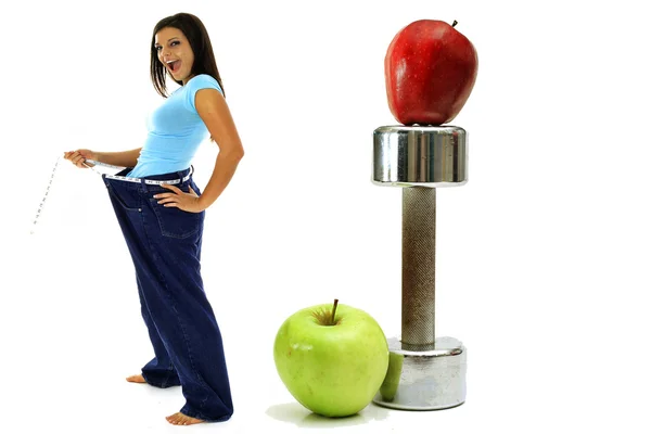 Hmotnost ztráta cvičení jablka bruneta v džínách Stock Snímky