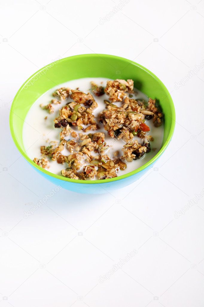 Granola cereal with milk on white vertical