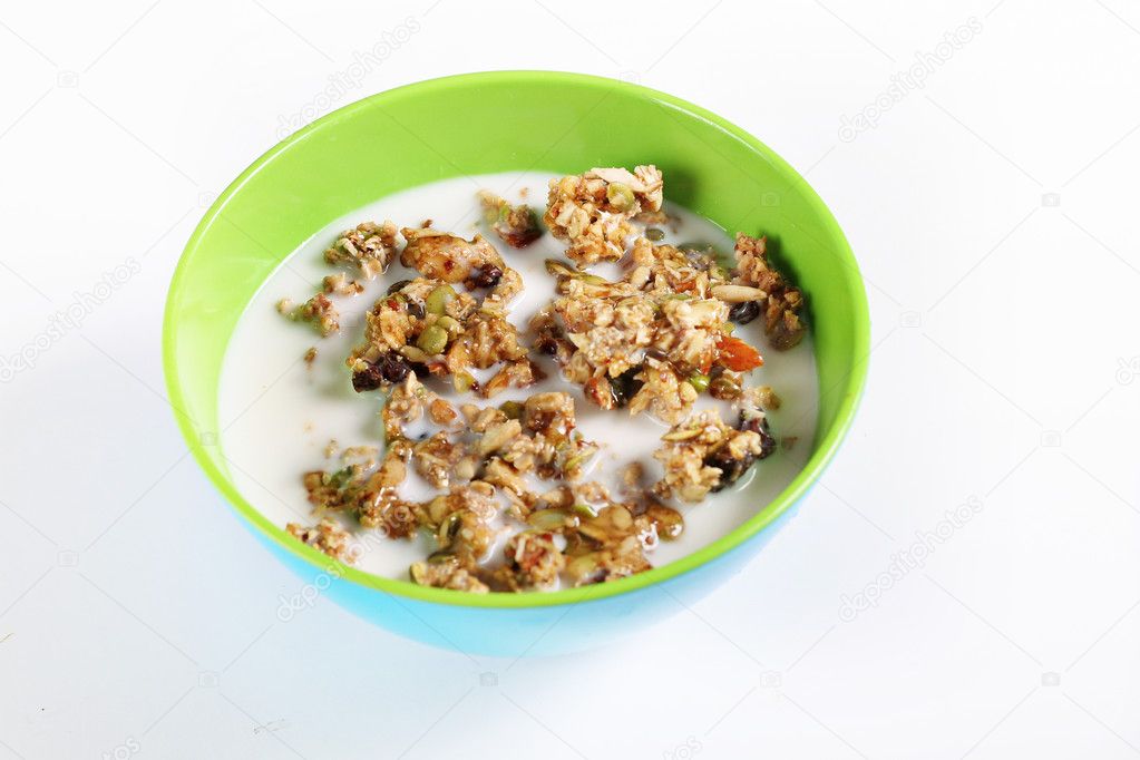 Granola cereal with milk on white