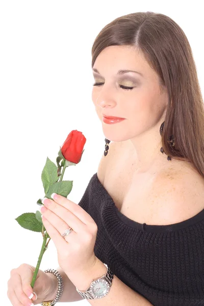 Shot of a brunette smelling a rose — Stock Photo, Image