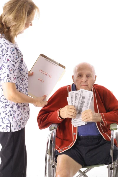 Elderly handicap senior paying medical bill — Stock Photo, Image