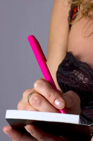 Sexy secretary with notebook and pen — Stock Photo, Image