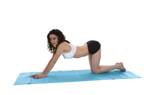 stock image Young woman on exercise mat