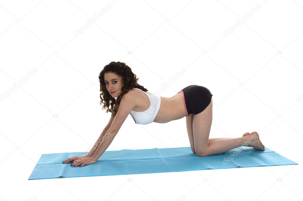 Young woman on exercise mat