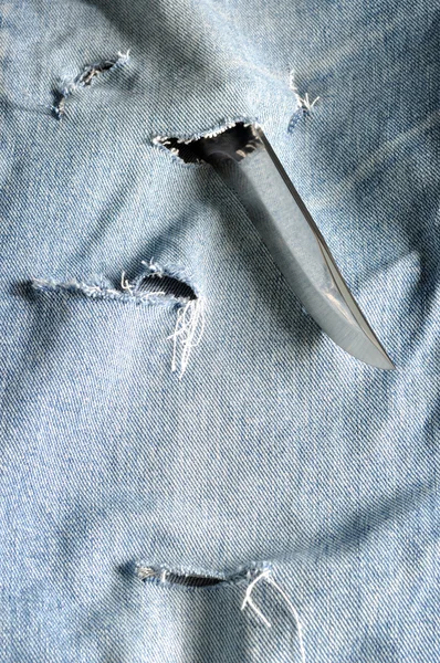 Torn jeans with sharp knife