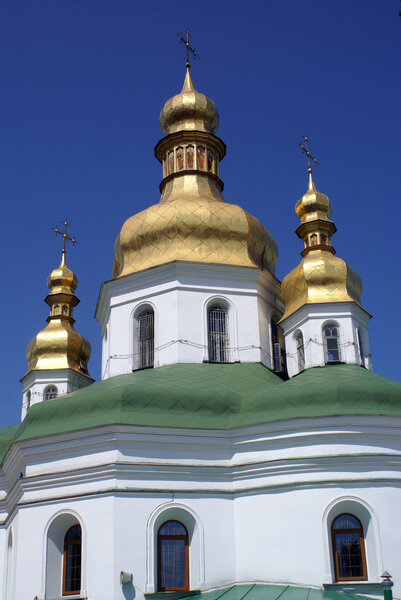 White church with golden cupolas in Lavra monastery in Kiev