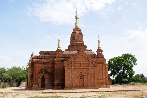 Brick temple with golden spire — Stock Photo, Image