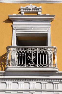 Yellow wall and white balcony clipart