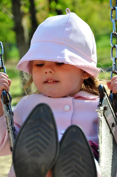 Cute toddler girl riding on swing — Stock Photo, Image