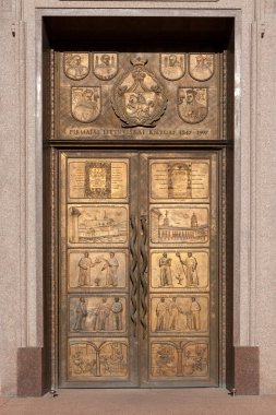 A bronze door at the Vilnius University clipart