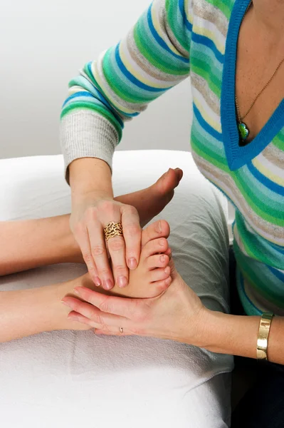 Closeup of teenagers foot during massage treatment at health cen — Stock Photo, Image