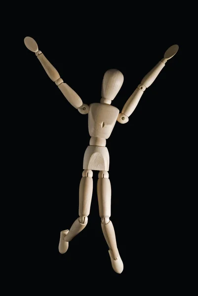 stock image Wooden figure with a black back ground jumping out of joy