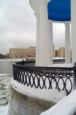 Rotunda fragment in park Bitter in the winter against the river, Moscow, Russia clipart