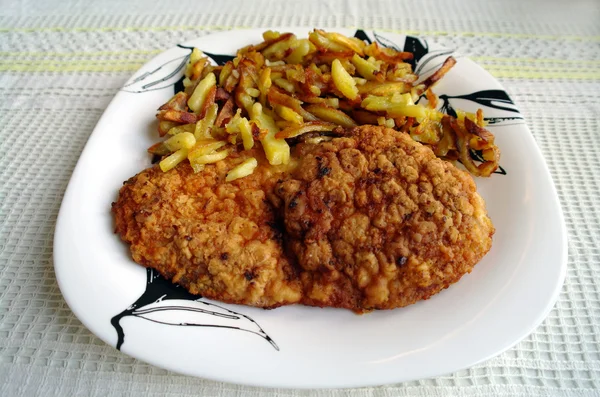 stock image Fried meat with a potato on a plate