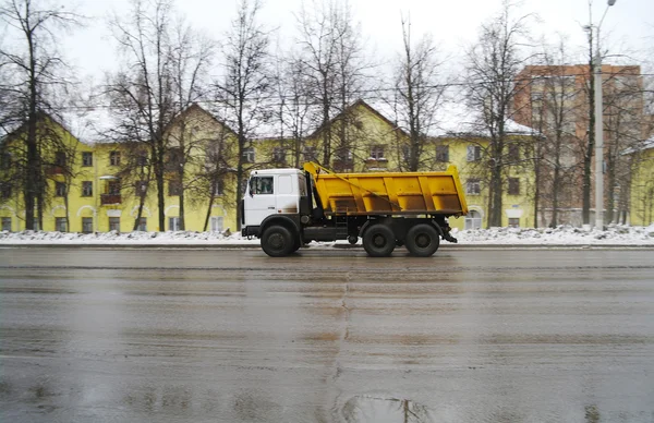 Der LKW fährt auf dem Weg zum Hintergrund des gelben Hauses — Stockfoto