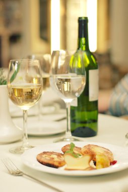 Wine bottle with glasses on table in restaurant clipart