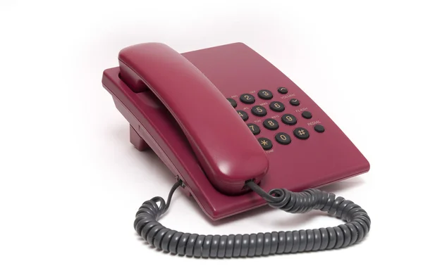 Kleurrijke rode telefoon op witte achtergrond Stockfoto