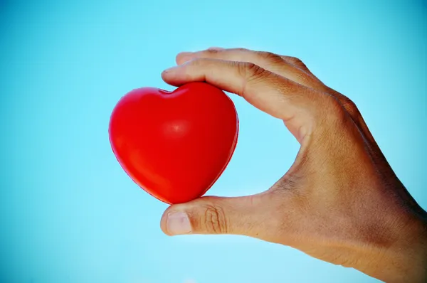 A hand holding a red hear — Stock Photo, Image