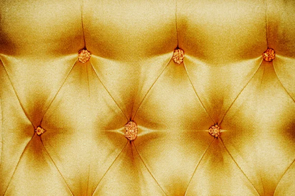 Golden satin cushioned textile — Stock Photo, Image
