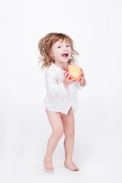 Cute child jumping with apple at hands — Stock Photo, Image