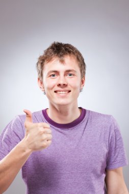 Happy handsome smiling young man, thumb up clipart