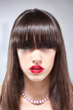 Brunette woman portrait with plumpy red lips clipart