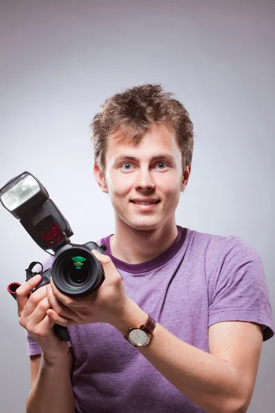 Happy surprised photographer with camera at hand — Stock Photo, Image