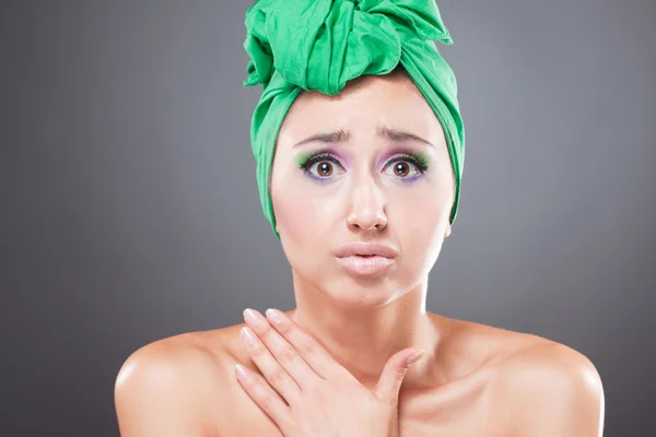 Frightened woman with green scarf on head — Stock Photo, Image