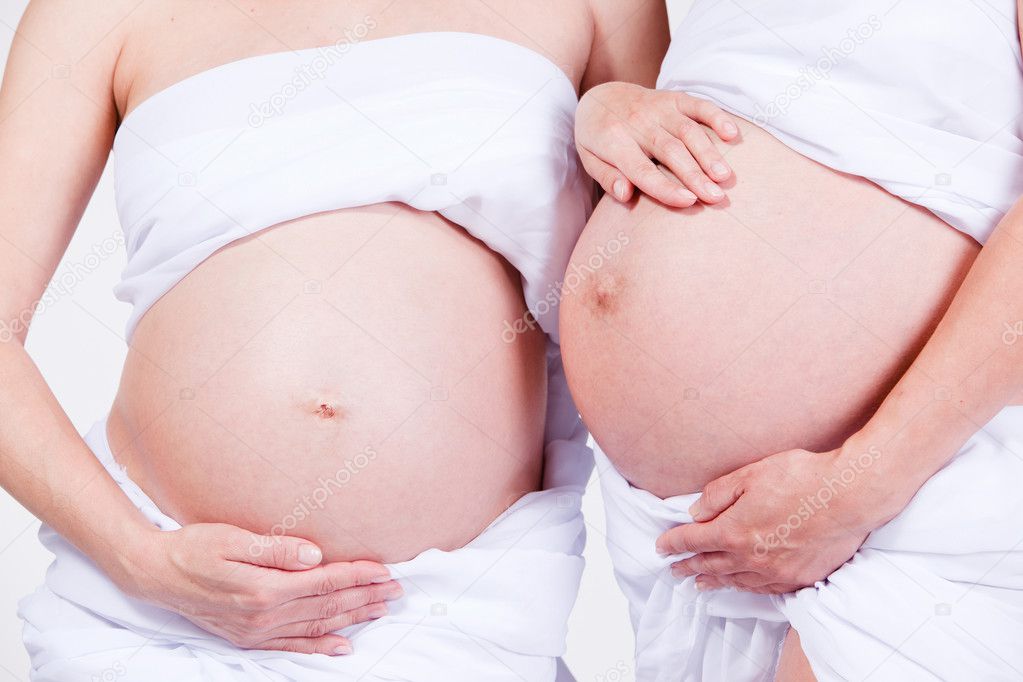 Closeup portrait of bellies of two pregnant women