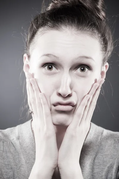 Upset sad young brunette woman holding face with hands — Stock Photo, Image