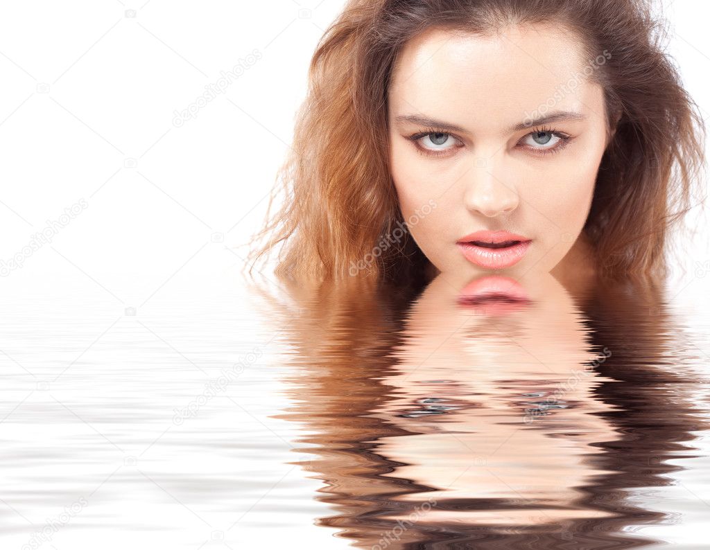 Passionate brunette woman face with reflection in the water