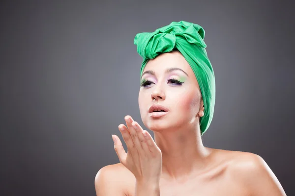Sexy pin-up woman with green scarf on head sending kiss — Stock Photo, Image