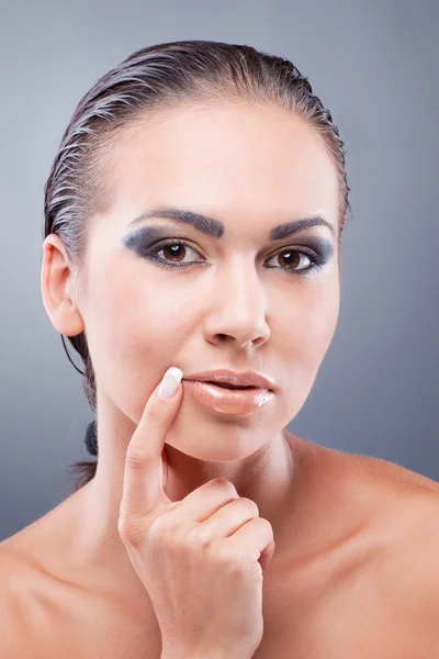 Passionate brunette woman holding finger near lips — Stock Photo, Image