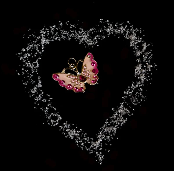 Butterfly in heart fron sugar in black background — Stock Photo, Image