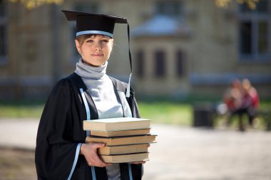 Graduate of university with books clipart
