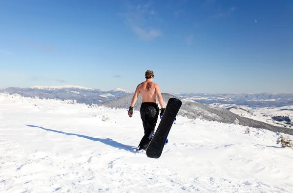 Snowboarder topless walk up on the mountain — Stock Photo, Image