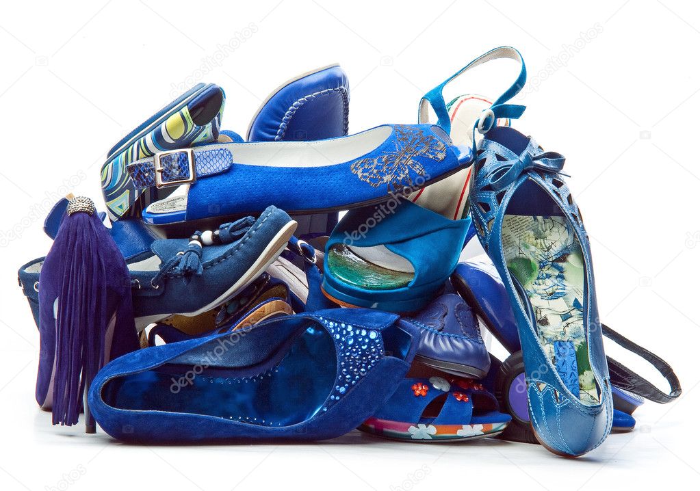 Pile of female blue shoes isolated on white background
