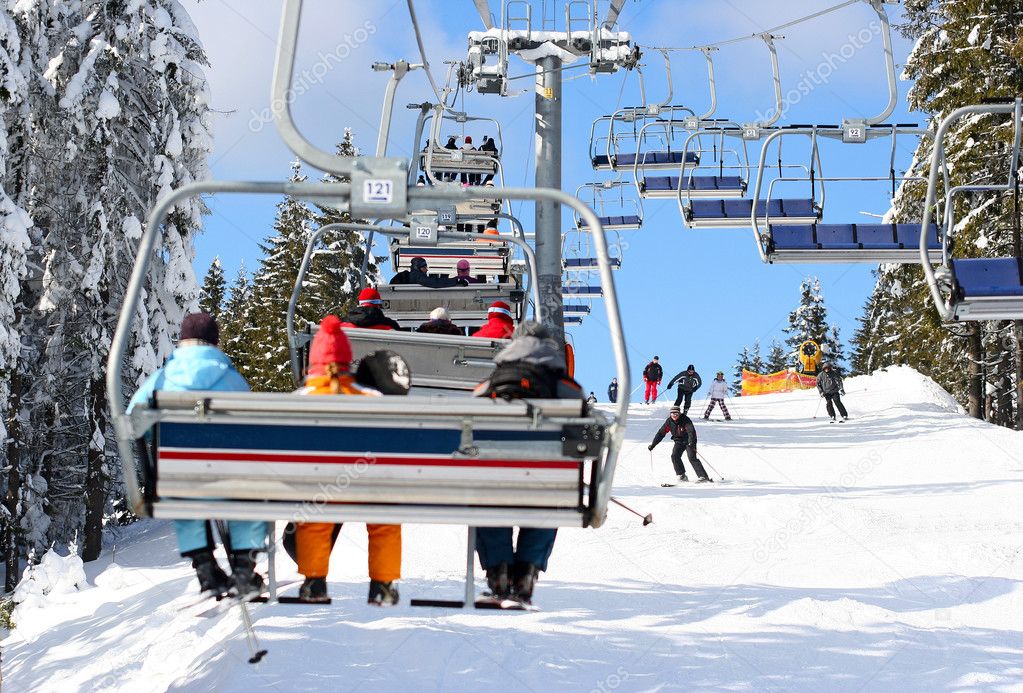 Skiers go on the lift on mountain in Bukovel, Ukraine