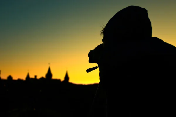 stock image Female photographer taking a picture at sunset