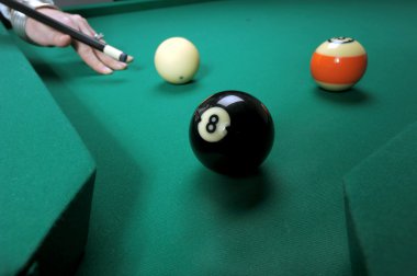 Woman hits balls on a pool table clipart