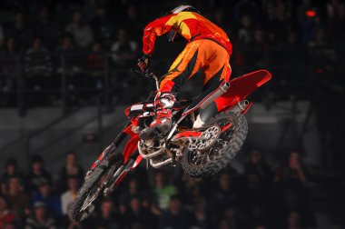 Freestyle moto-x rider during competition clipart