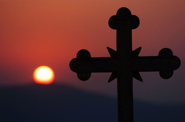 church cross over sun setting 