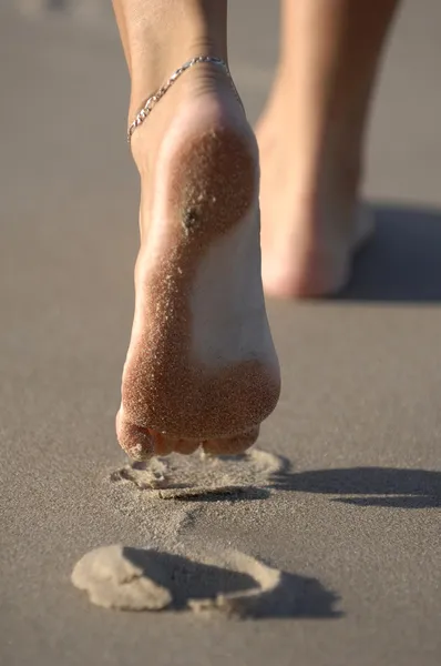 Női láb homokos strandon — Stock Fotó