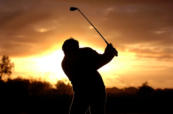 Silhouette golfista alla luce del mattino Fotografia Stock