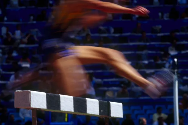 Female runners on hurdle competition — Stock Photo, Image